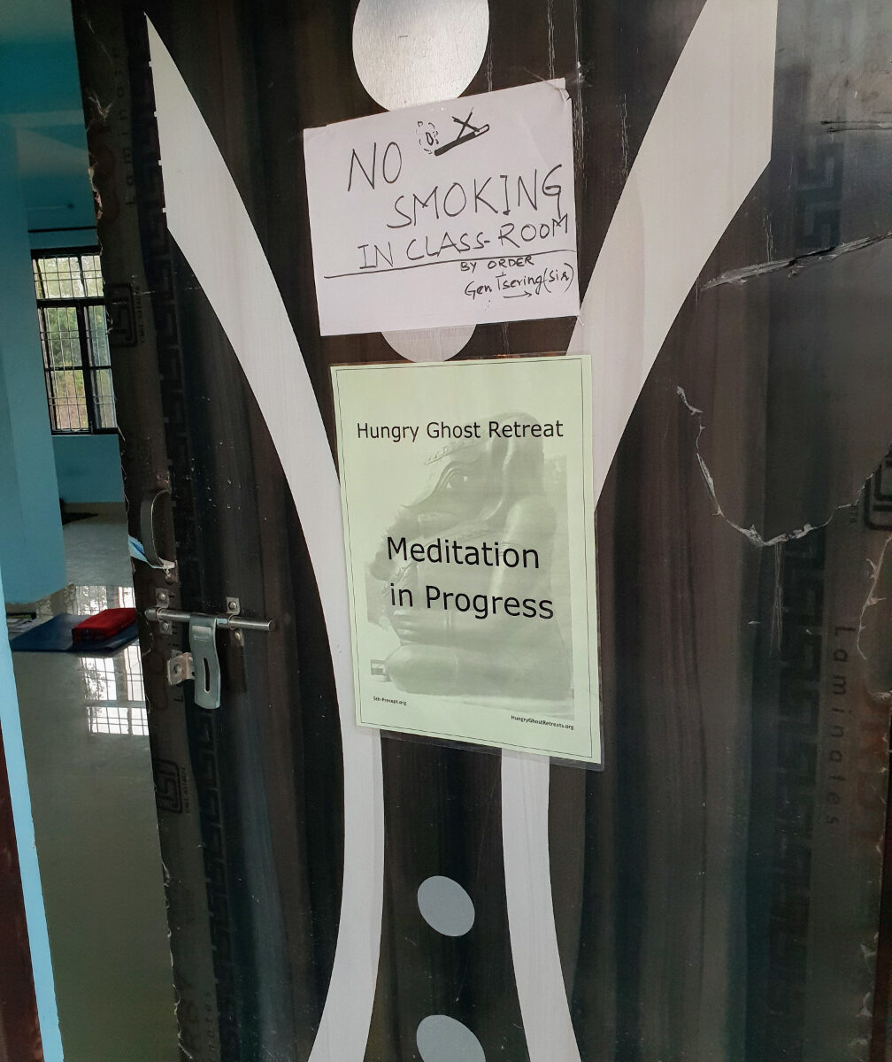 Partly open door with sign "Meditation in Progress"