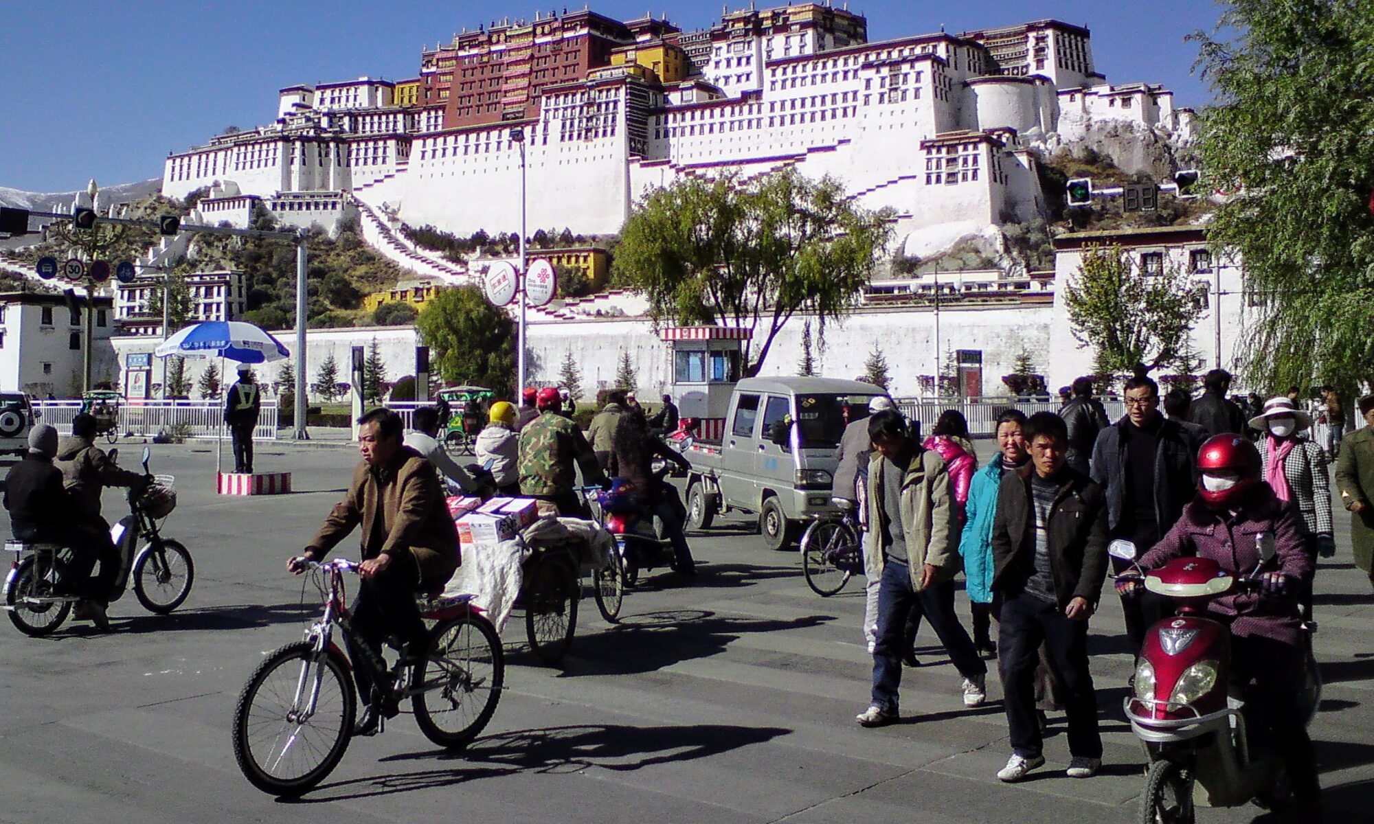 Crowds crossing street in front of the Potala Palace - Lhasa, Tibet- November 2008