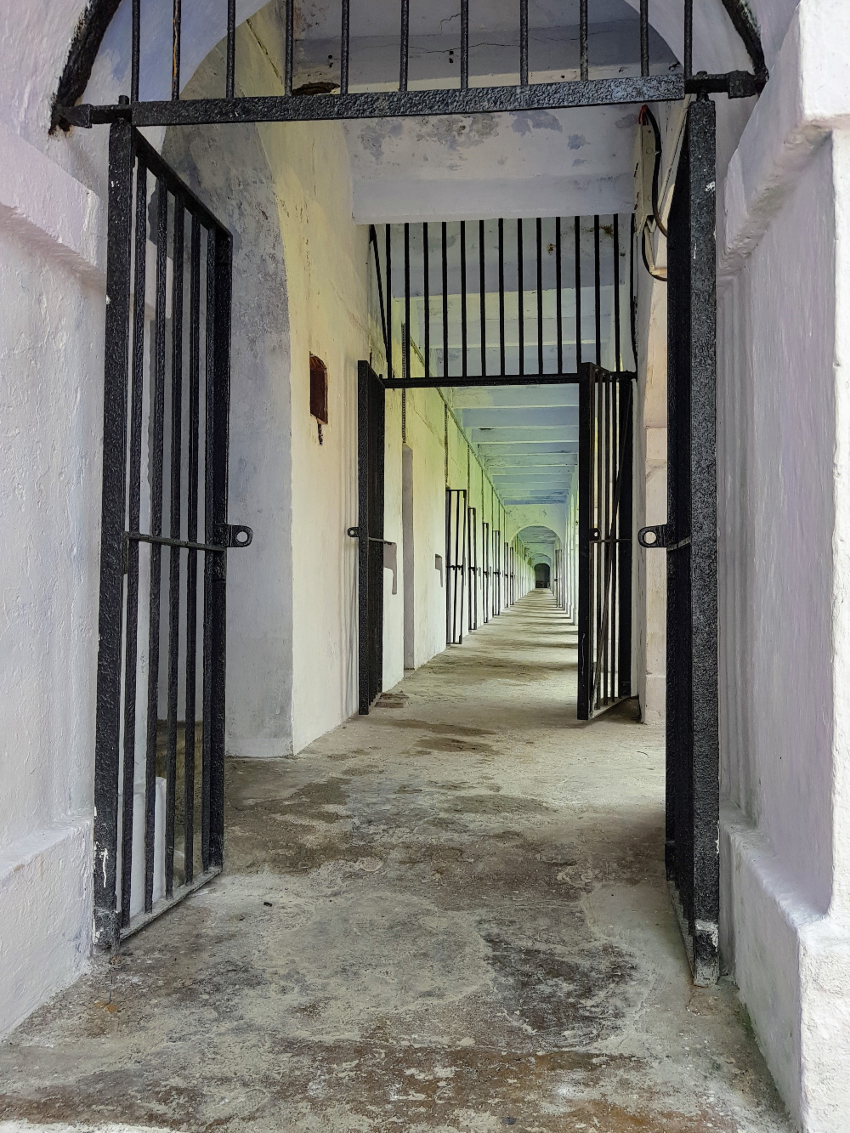 Photo of long deserted prison corridor.